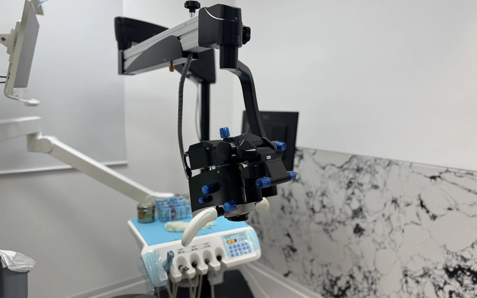 Clinical microscope in a dental treatment room at Arrail Dental